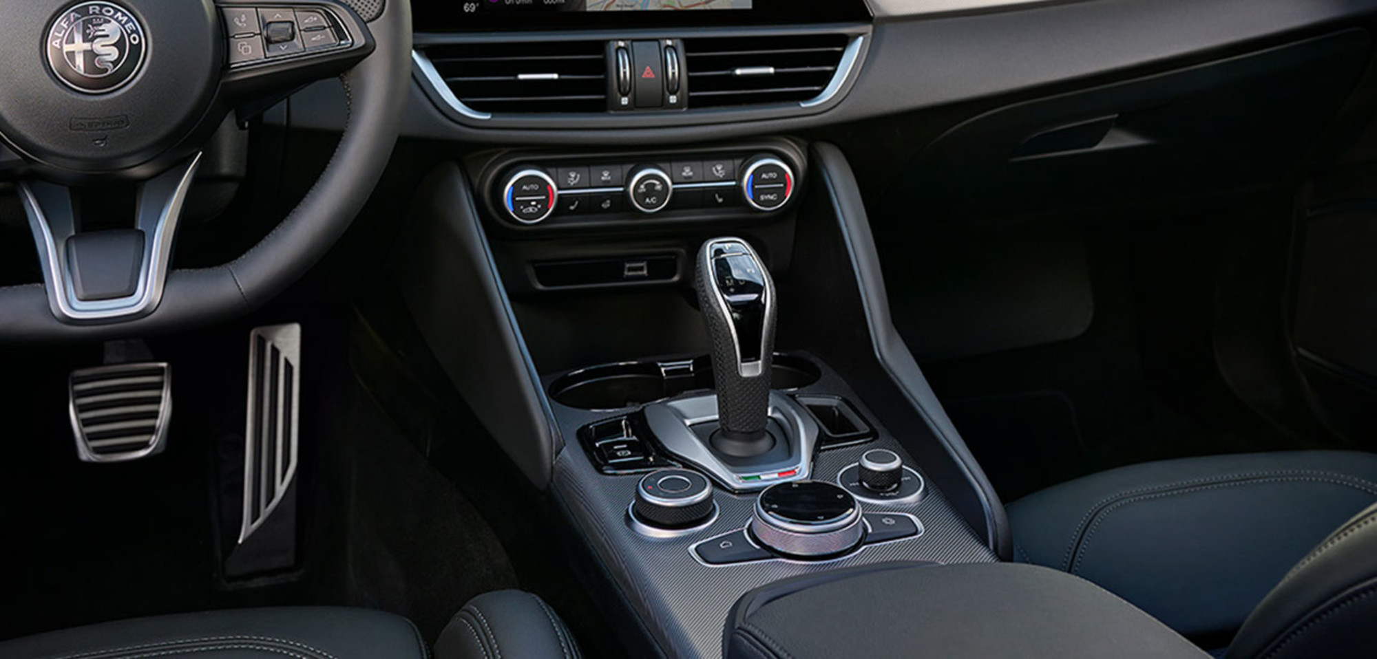 Interior of a 2025 Alfa Romeo Giulia showcasing the Dual Zone Climate Control and central console features.
