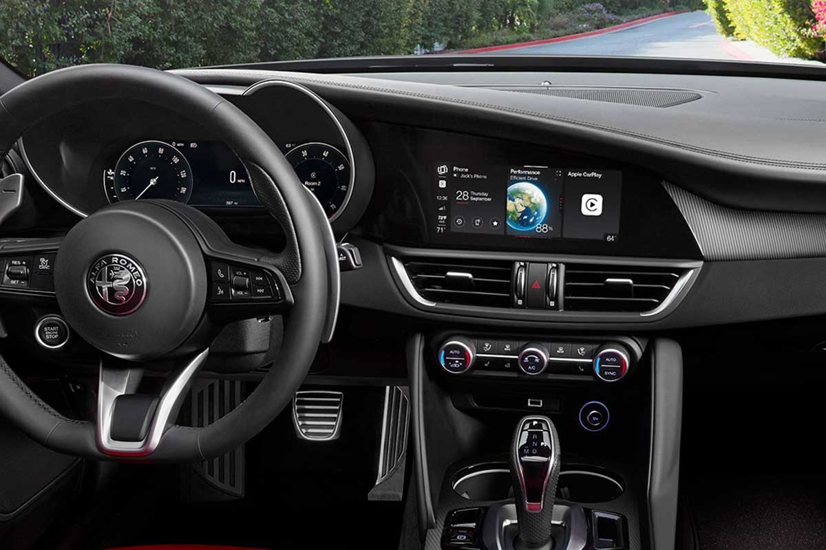 The centre console screen displaying a connected phone, car performance, and Apple CarPlay.