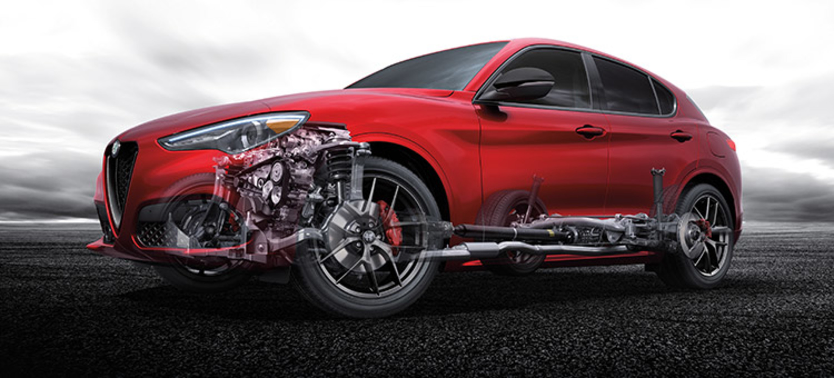 Side view of the red Alfa Romeo Stelvio, with the engine visible under the hood