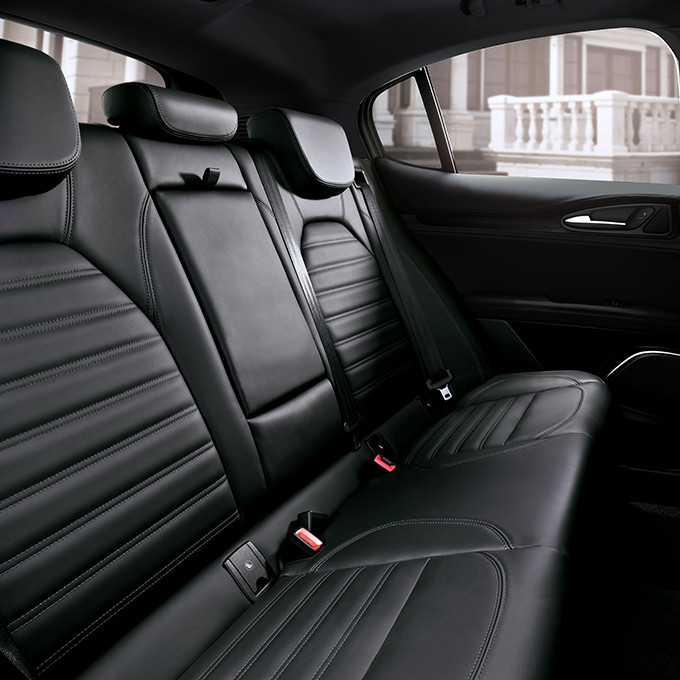 Back row of an Alfa Romeo Stelvio featuring black leather seats.