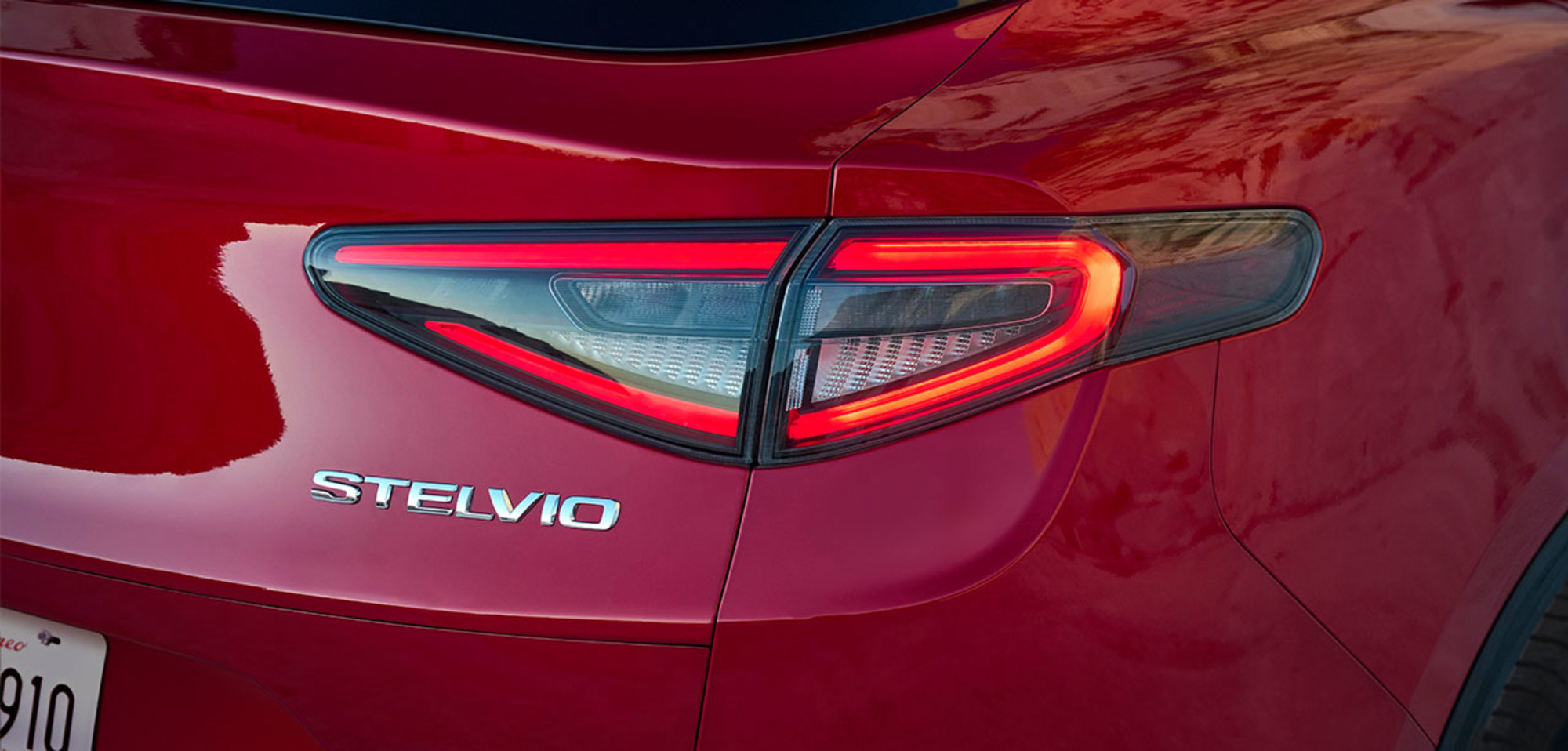Une vue rapprochée de l’insigne sur une Alfa Romeo Stelvio 2025 rouge.