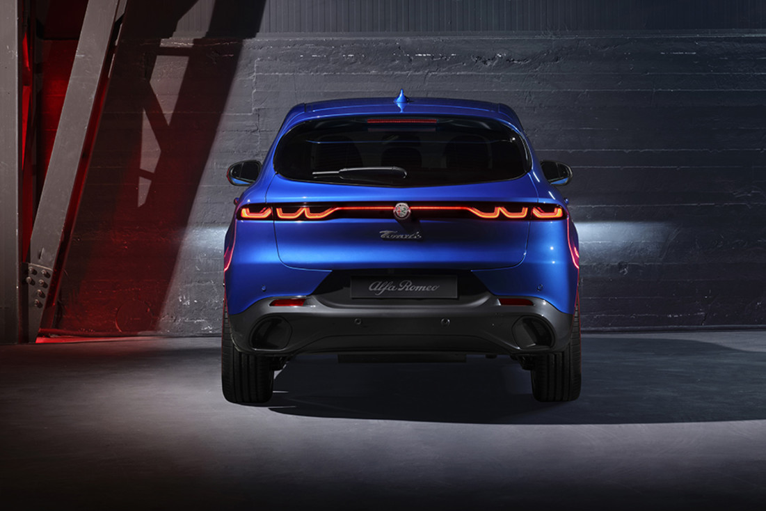 Rear view of a parked blue 2024 Alfa Romeo Tonale PHEV.