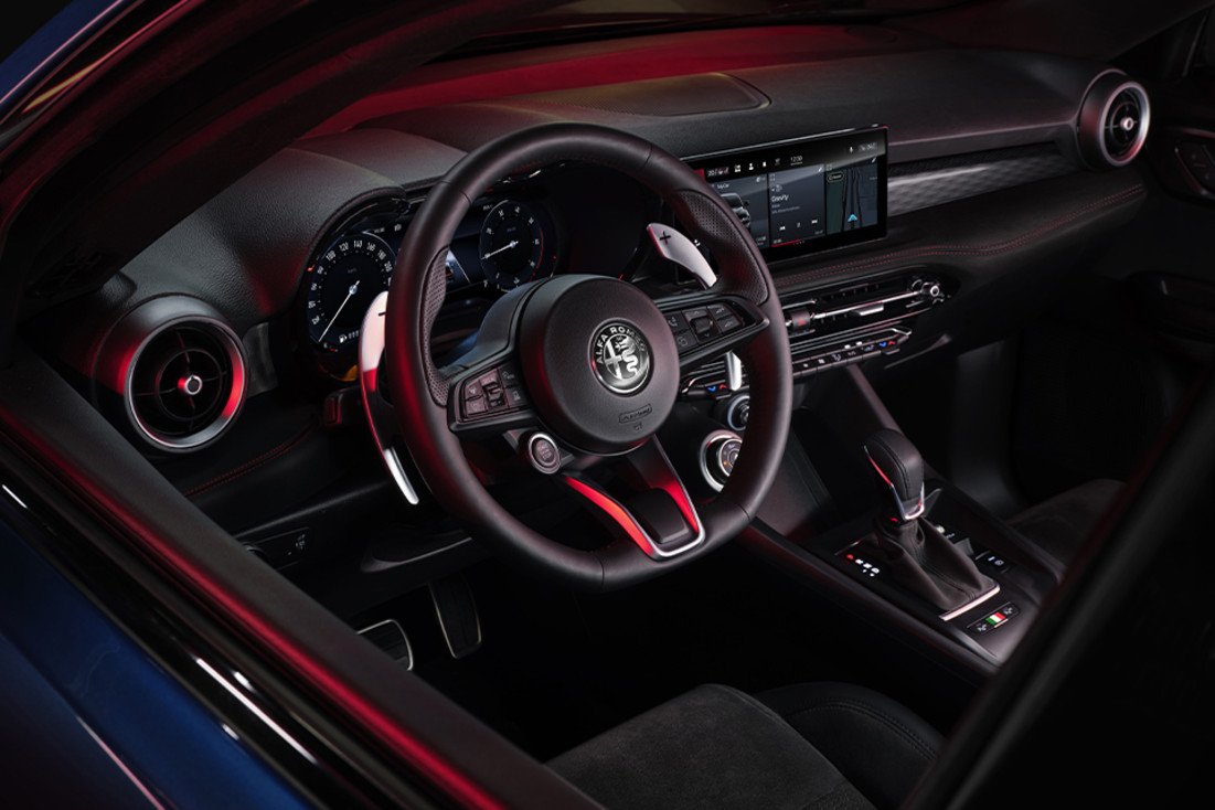 Close-up of a black steering wheel for the 2024 Alfa Romeo PHEV.