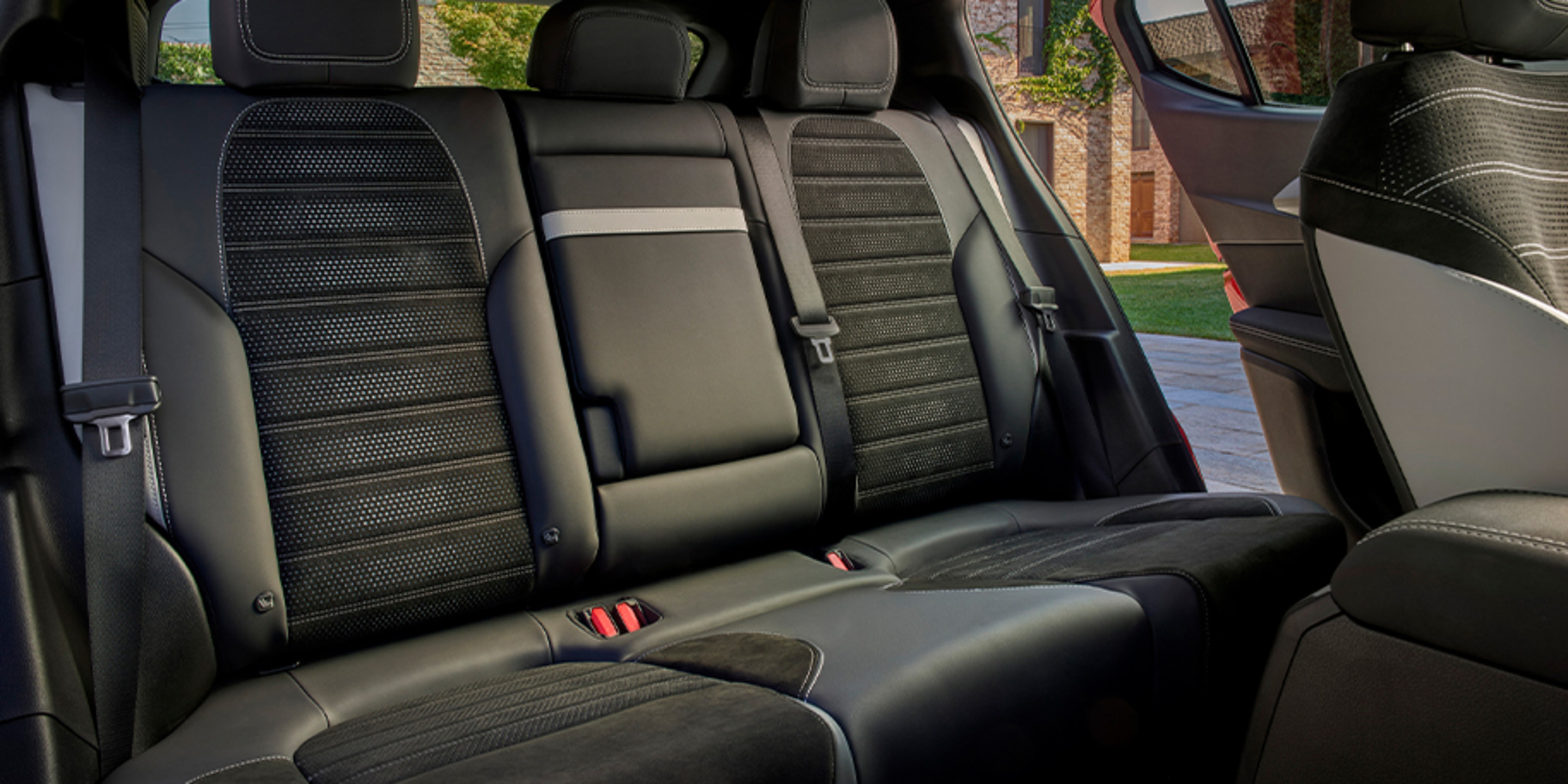 Interior of a 2026 Alfa Romeo Tonale Gas showcasing the spacious rear seats with luxurious leather upholstery and stylish stitching.