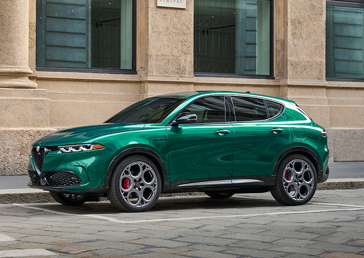 2025 Alfa Romeo Tonale PHEV Veloce in a vibrant green color, parked on a city street.