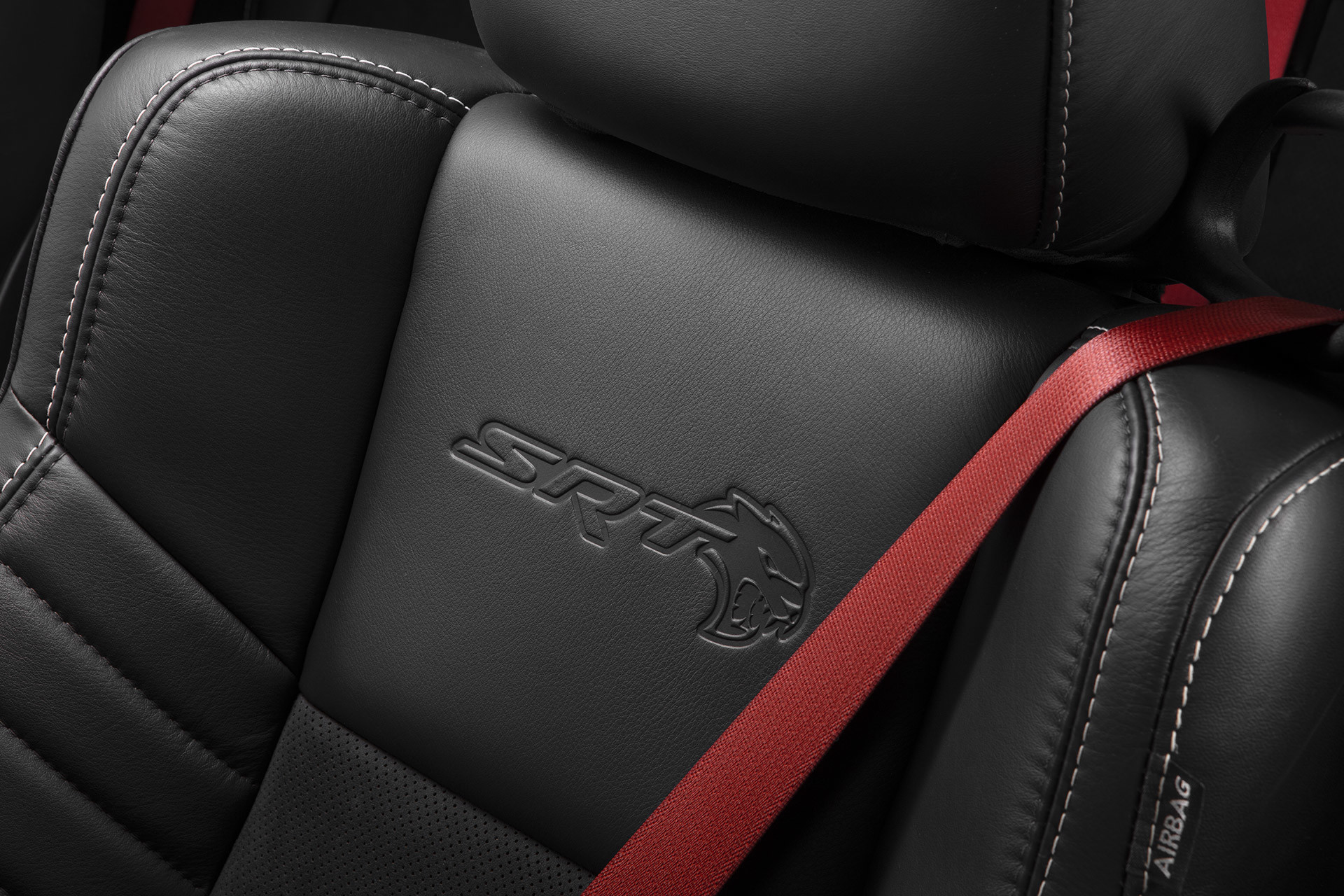 The SRT logo on the laguna leather seats of a 2022 Dodge Challenger.