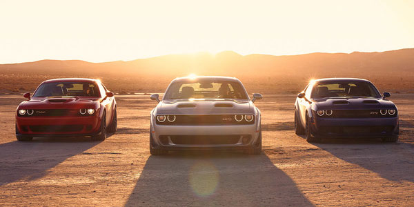 Front view of three 2023 Dodge Challenger parked in the desert.