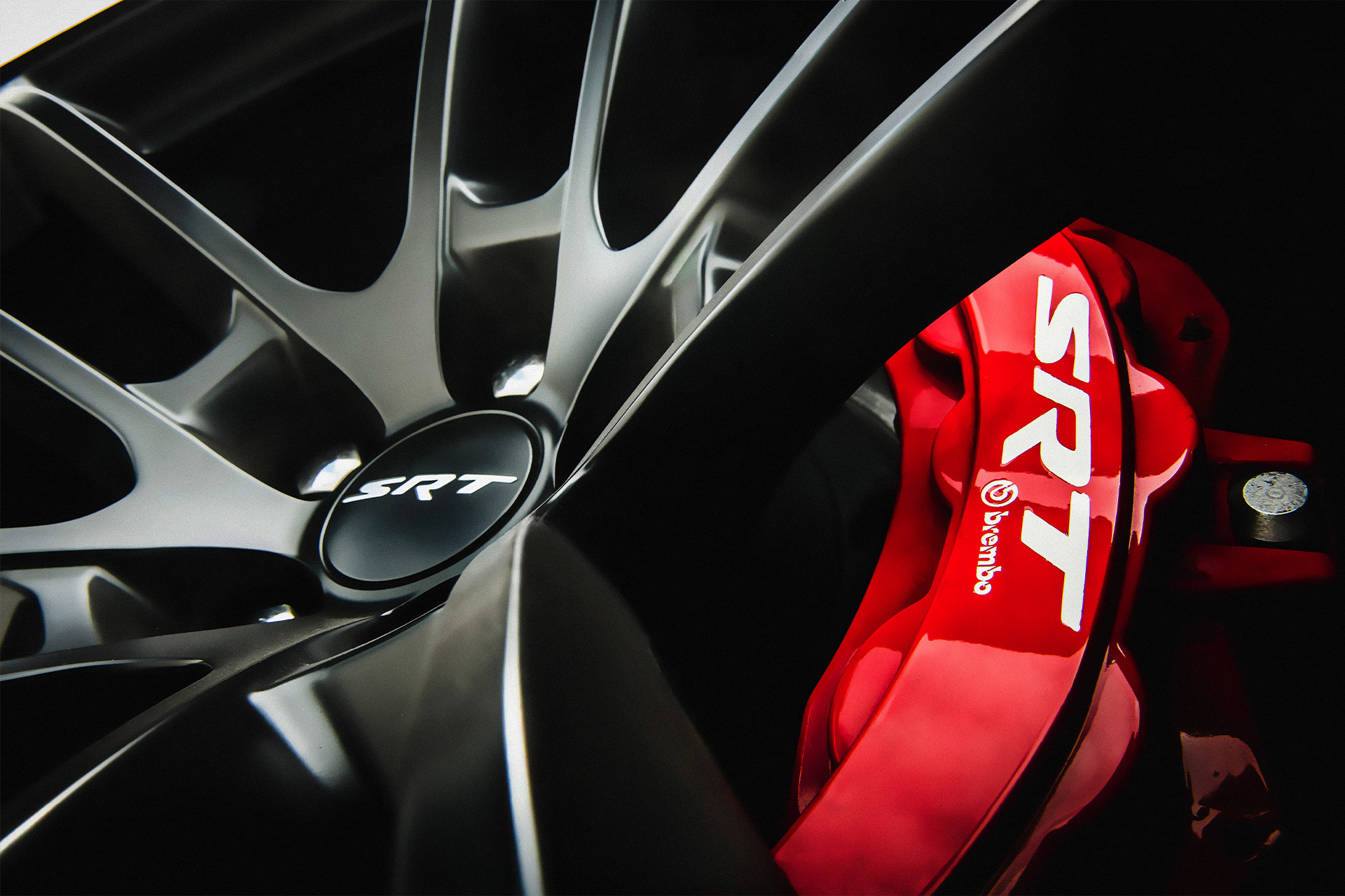 A close up of the four-piston Brembo Brake System in red on the Dodge Charger