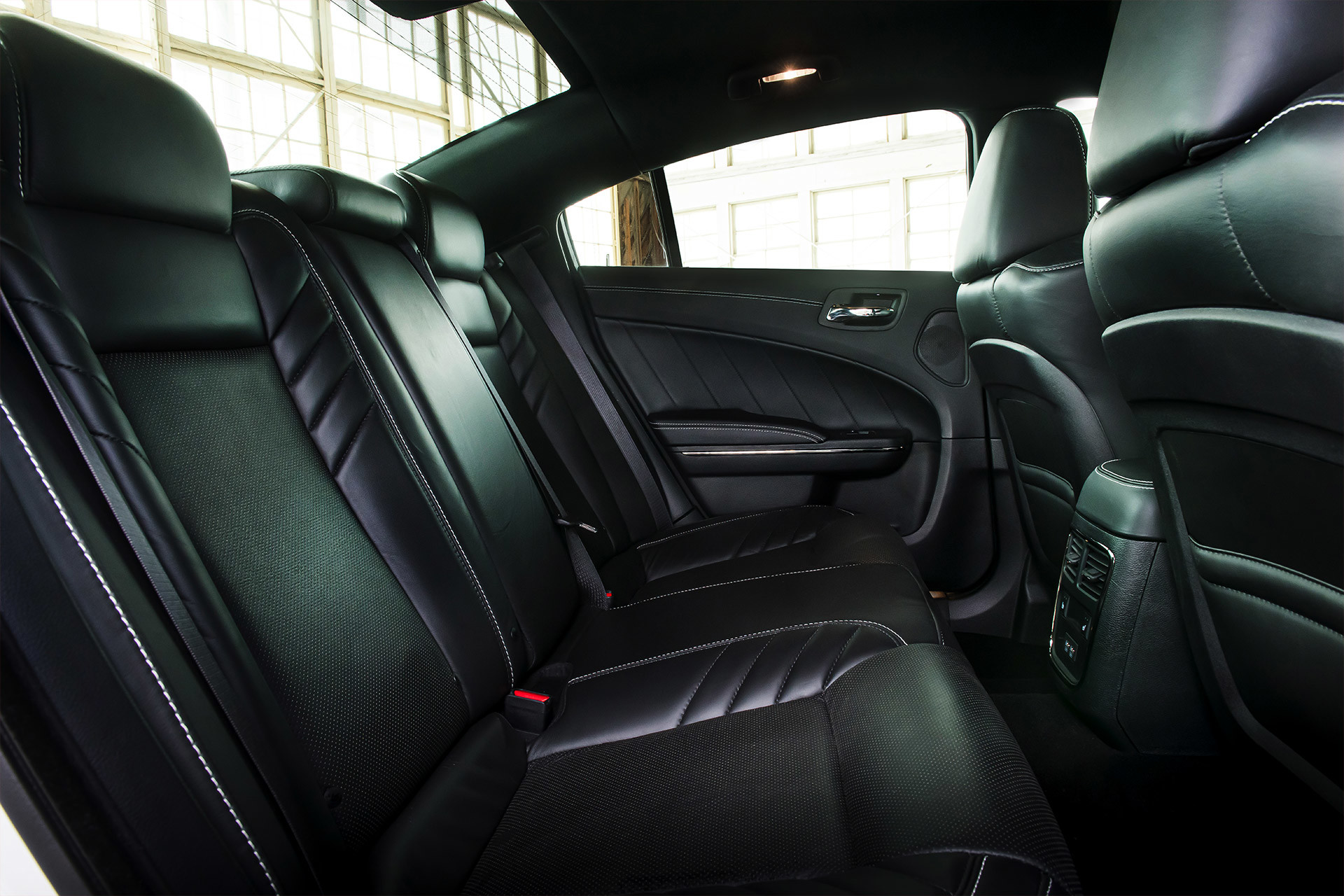 The back seats of a Dodge Charger in black leather