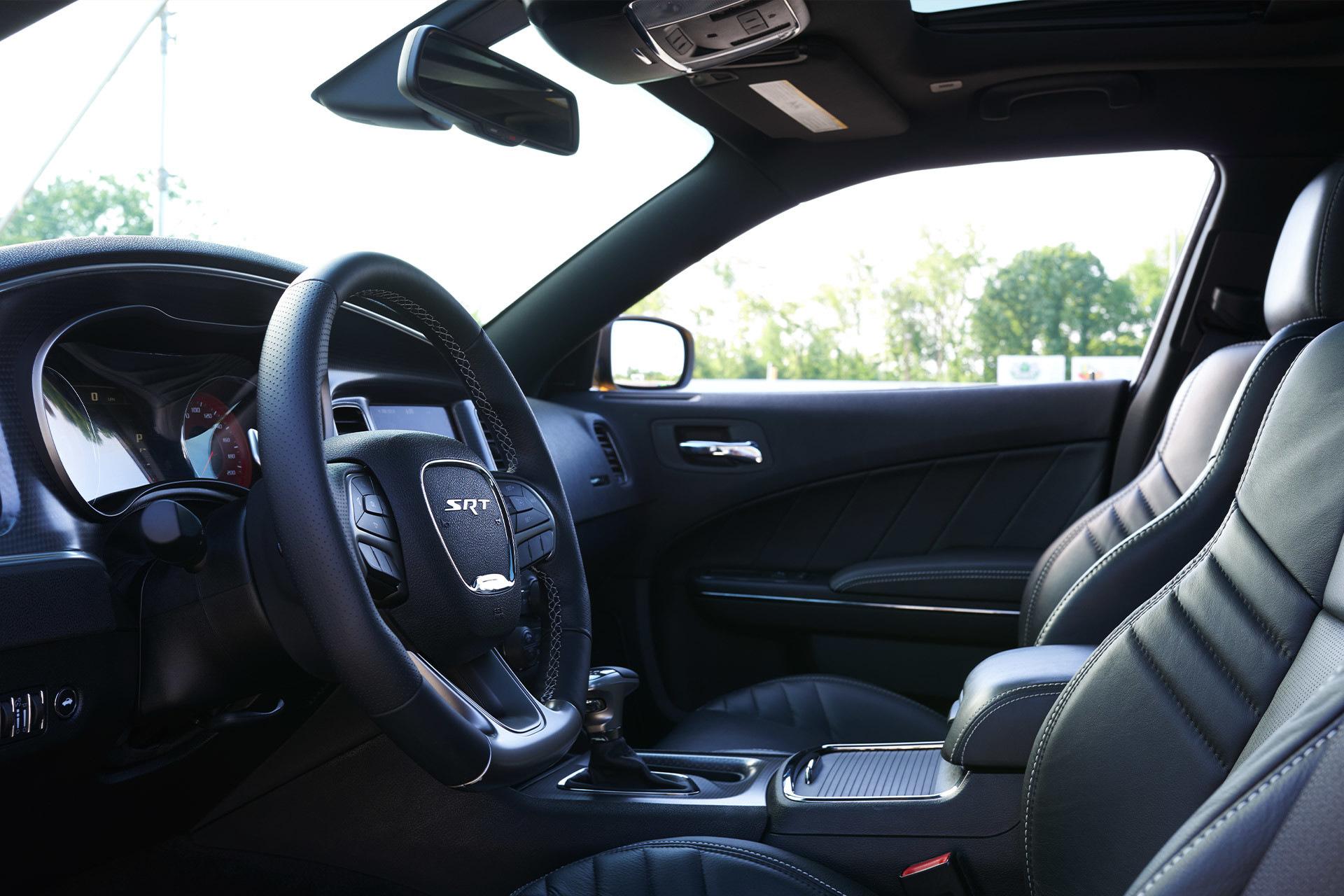 The front seat interior of a 2022 Dodge Charger in a black finish