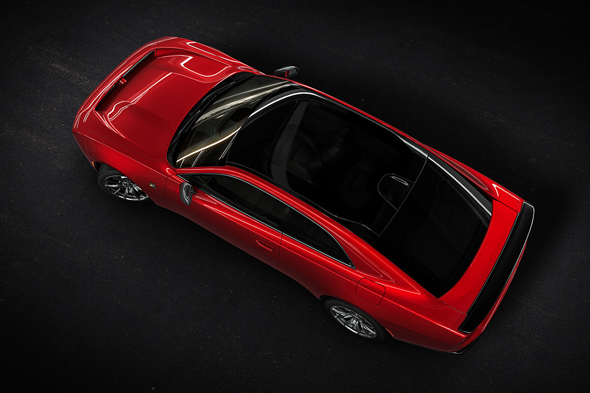 A bird’s eye view of a red Dodge vehicle shown parked on a black surface.