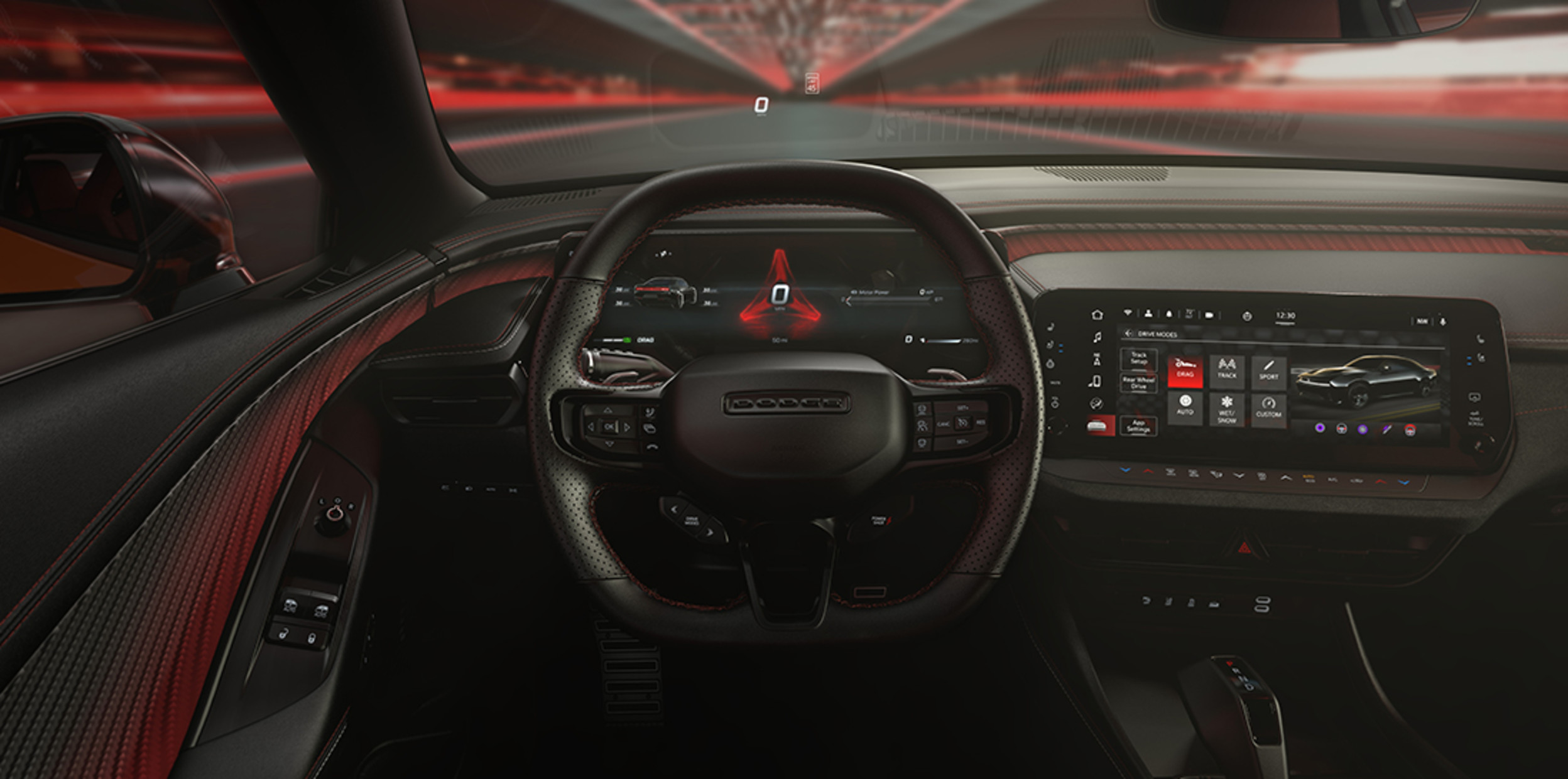 A close-up of the steering wheel inside a Dodge vehicle, from the driver seat.
