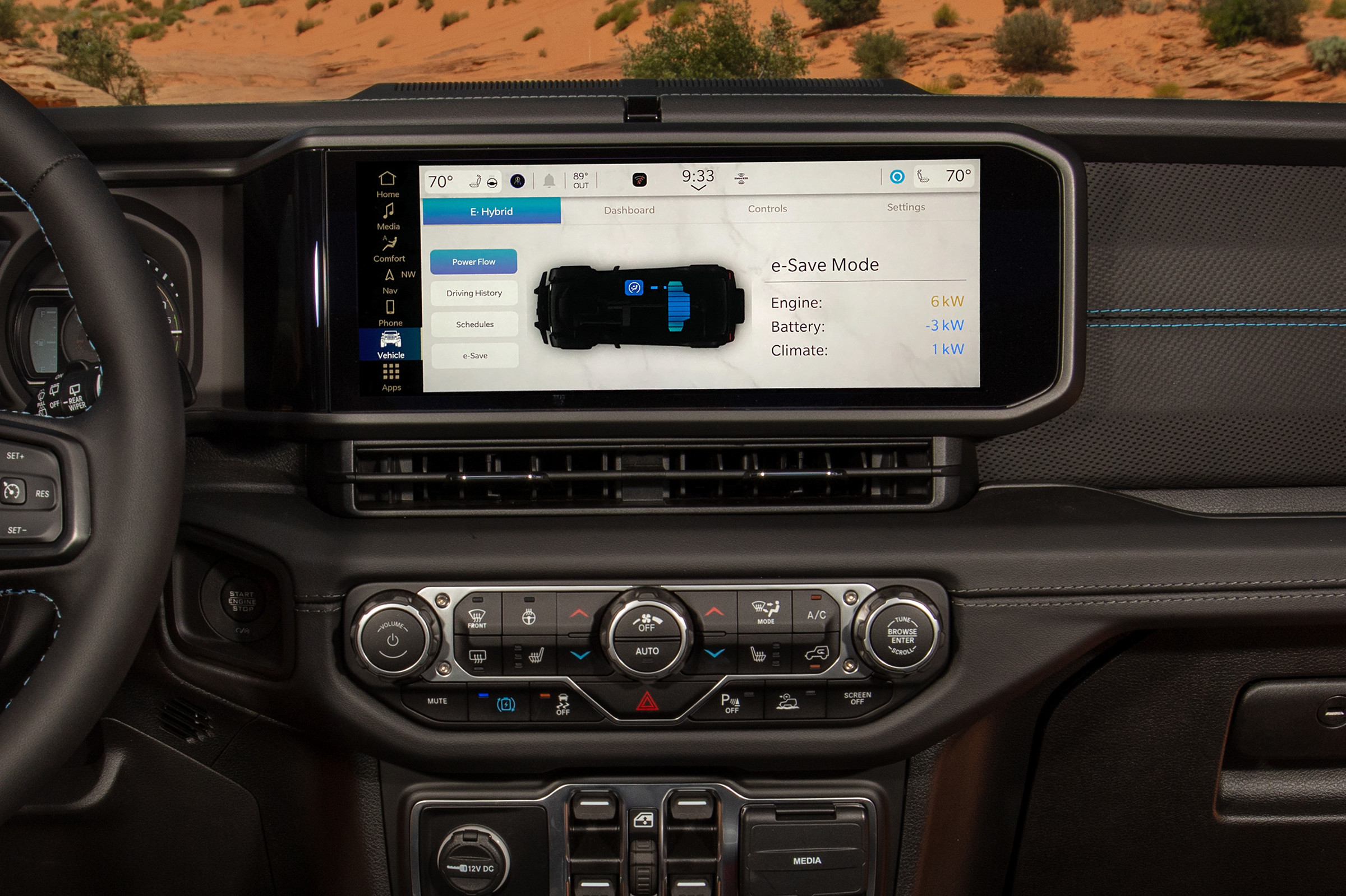 A smartphone showing the Jeep App on the screen is superimposed on an image of a Jeep parked on a road with buildings behind it.