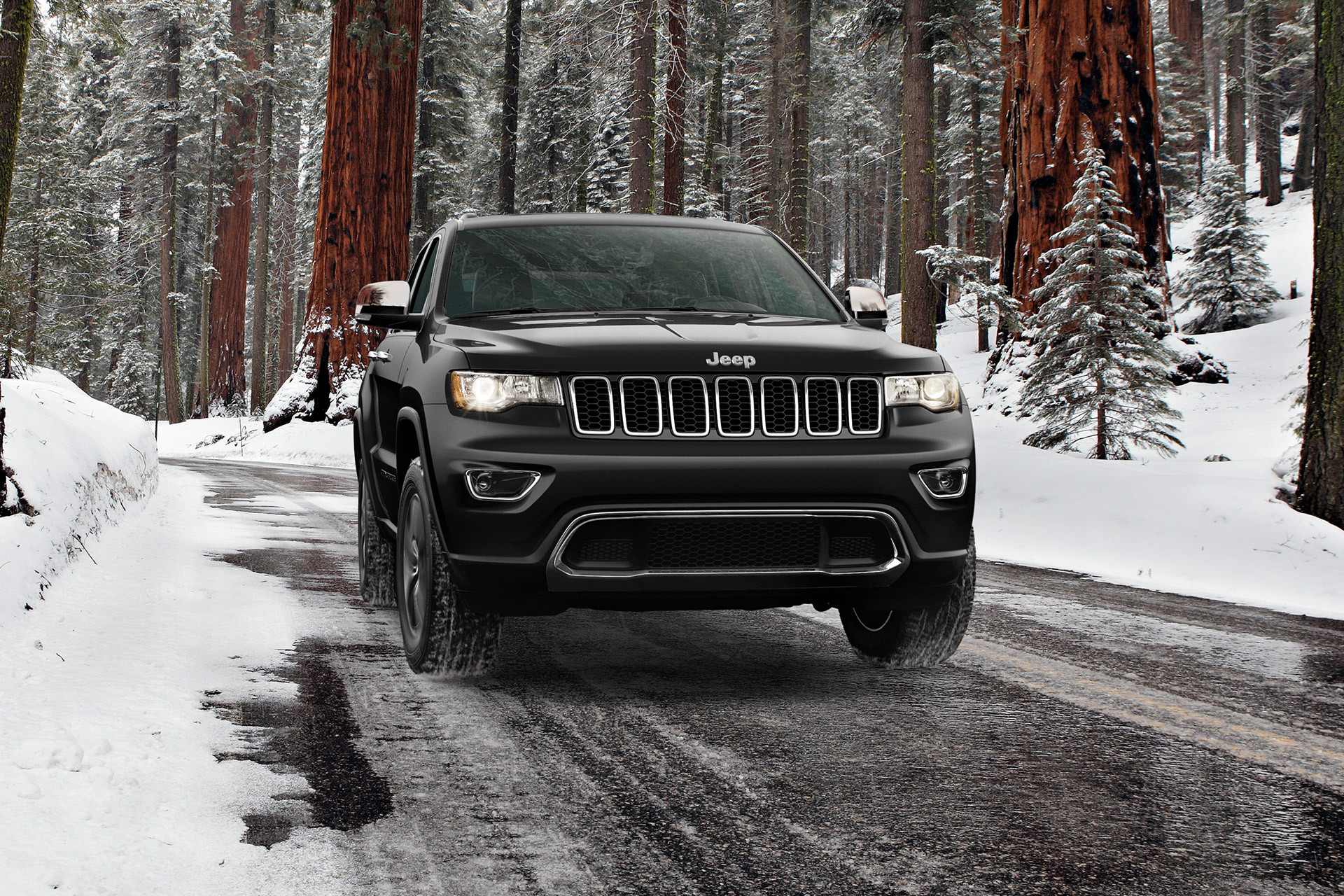 2022 Grand Cherokee WK Limited driving on a snowy road in a forest