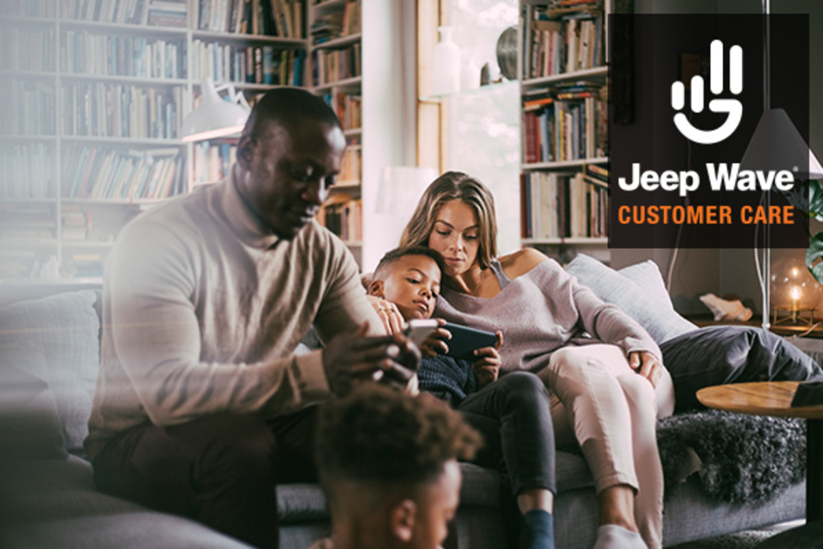 A family sitting in a living room, looking at mobile devices. Jeep Wave Customer Care.