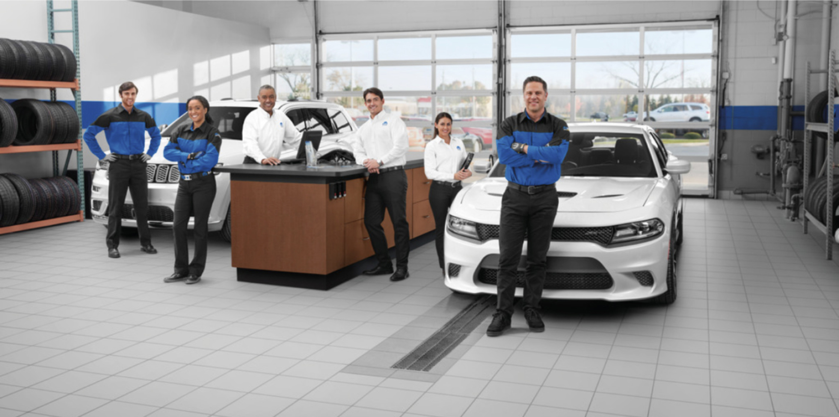 Several Mopar service specialists ready to welcome customers to a store.