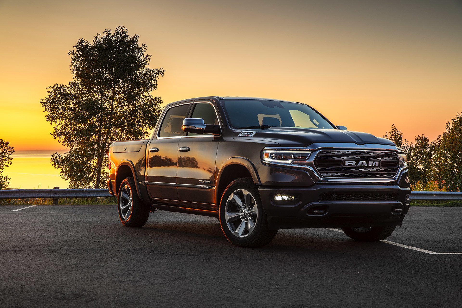  2021 Ram 1500 driving on a road at sunset.