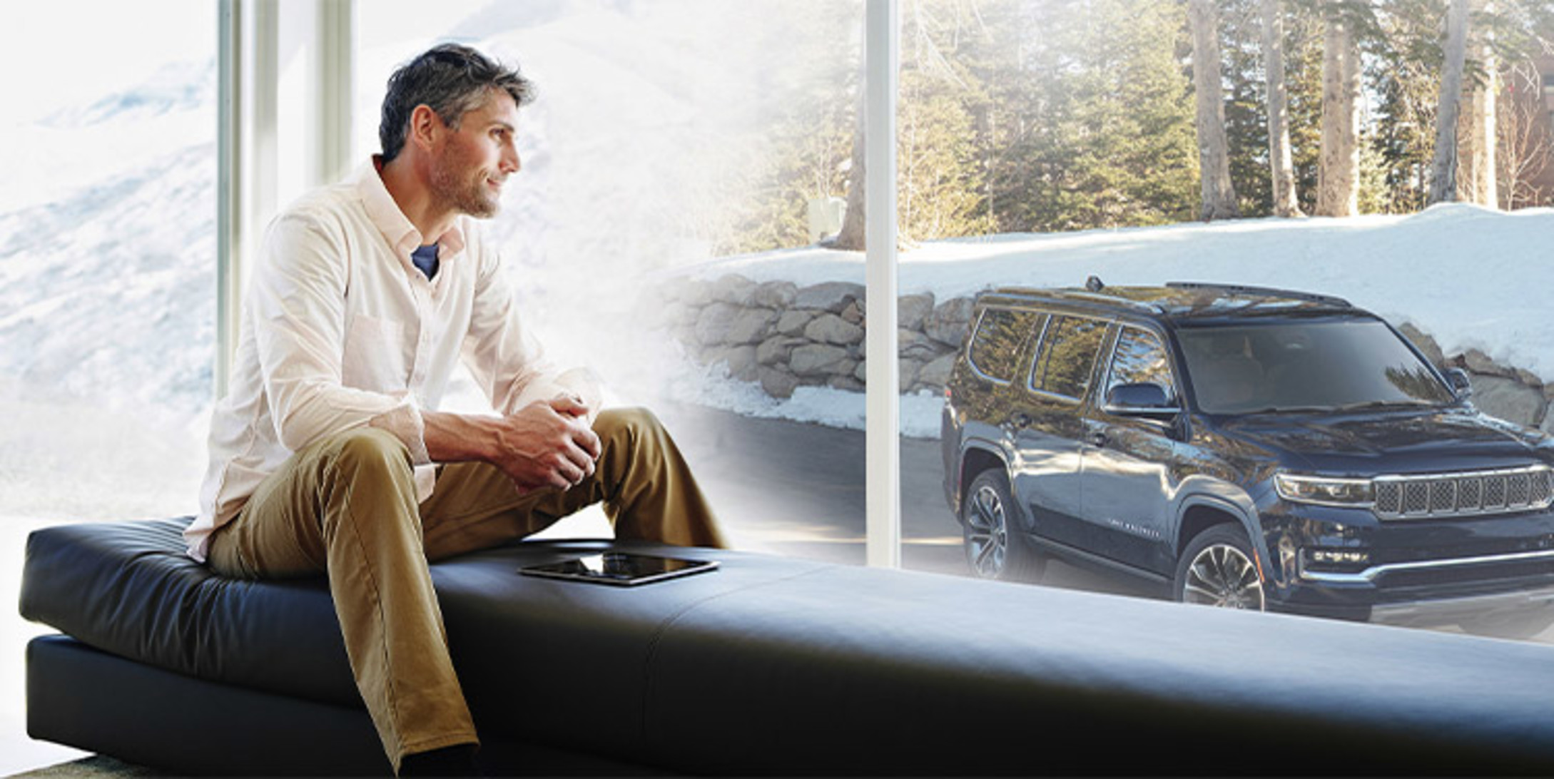 Man gazing out the window looking at blue Grand Wagoneer.