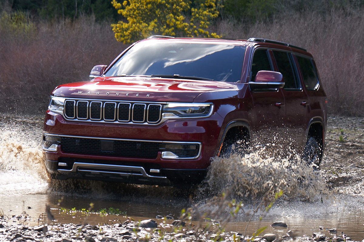 Front view of a red 2022 Wagoneer driving through water