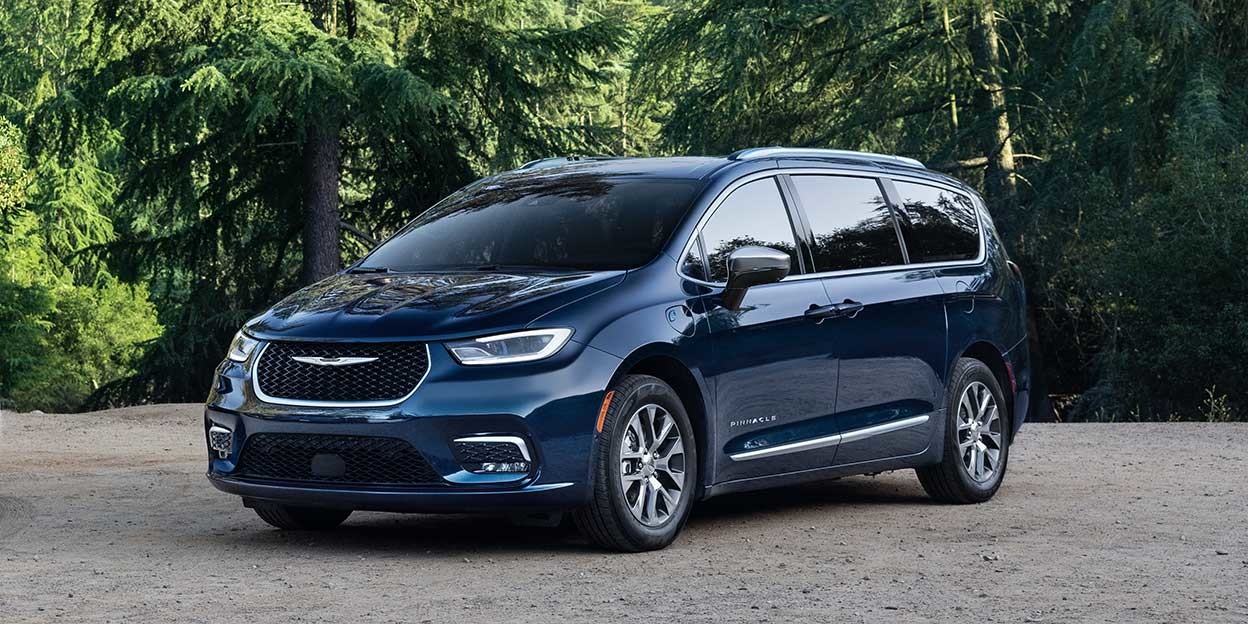 Silver 2025 Chrysler Pacifica Hybrid shown on a test drive setting, reflecting its road-trip readiness