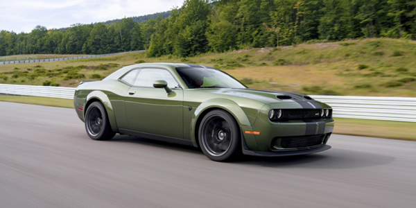 Green 2020 Dodge Challenger speeding on the road