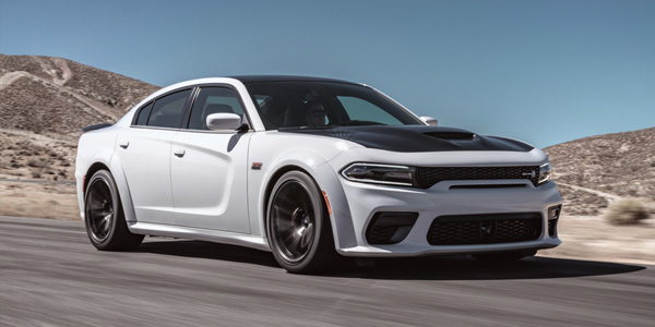 White 2020 Dodge Charger speeding on the road in the desert