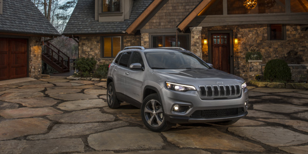 Grey 2021 Jeep Cherokee parked on the driveway of a cottage home